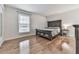 Bright bedroom with hardwood floors, featuring a queen bed and ample natural light from a large window at 6700 Roswell Rd # 24E, Atlanta, GA 30328