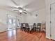 Bright dining room with hardwood floors, a table set for six, and a ceiling fan for added comfort at 6700 Roswell Rd # 24E, Atlanta, GA 30328