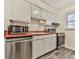 Functional kitchen featuring white cabinets, stainless steel appliances, and wood countertops at 6700 Roswell Rd # 24E, Atlanta, GA 30328