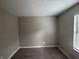 This bedroom features neutral walls, plush carpet, and a window for natural light at 885 Hemingway Rd, Stone Mountain, GA 30088