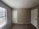 This neutral bedroom features plush carpet and a window for natural light at 885 Hemingway Rd, Stone Mountain, GA 30088