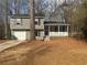 Charming two-story home featuring a front porch and attached garage at 885 Hemingway Rd, Stone Mountain, GA 30088