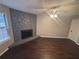 Cozy living room with a stone fireplace and hardwood floors at 885 Hemingway Rd, Stone Mountain, GA 30088