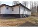 View of the back of the home with new paint and mature landscaping at 4289 Post Rd, Winston, GA 30187