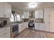 Bright kitchen featuring white cabinets, stainless steel appliances, and granite countertops at 4289 Post Rd, Winston, GA 30187