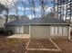 Exterior showcasing a flat backyard with a patio and bare planting beds at 5073 Martins Crossing Rd, Stone Mountain, GA 30088