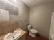 Bathroom featuring a tub shower, toilet, and vanity sink with modern fixtures at 5073 Martins Crossing Rd, Stone Mountain, GA 30088