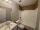 Bright bathroom featuring a tub shower, toilet, and vanity sink with modern fixtures at 5073 Martins Crossing Rd, Stone Mountain, GA 30088