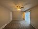 Bedroom boasts neutral paint, plush carpet, ceiling fan, and patio access at 5073 Martins Crossing Rd, Stone Mountain, GA 30088
