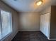 Comfortable bedroom with neutral carpet, a window for natural light, and a closet for storage at 5073 Martins Crossing Rd, Stone Mountain, GA 30088