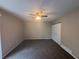 Neutral bedroom showcasing carpet, ceiling fan, and closet for ample storage at 5073 Martins Crossing Rd, Stone Mountain, GA 30088
