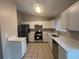 Bright kitchen with white cabinets, stainless steel appliances, and tile flooring, offering ample counter space at 5073 Martins Crossing Rd, Stone Mountain, GA 30088