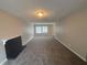 Spacious living room with neutral carpet, a fireplace, and large windows for ample natural light at 5073 Martins Crossing Rd, Stone Mountain, GA 30088