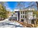 Modern home exterior featuring a multi-tone facade, large windows, and a driveway leading to the entrance at 600 Colebrook Ct, Atlanta, GA 30327