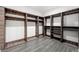 Spacious walk-in closet with wood-look shelving and drawers, and tile flooring at 600 Colebrook Ct, Atlanta, GA 30327