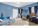 Charming bedroom features a blue accent wall, playful decor, and two bright windows at 635 Piping Rock Pt, Lawrenceville, GA 30043