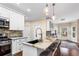 This kitchen offers granite countertops, stainless steel appliances, an island with seating, and abundant storage at 635 Piping Rock Pt, Lawrenceville, GA 30043