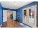Bright living room with access to an outdoor pool area via French doors, and features hardwood floors at 635 Piping Rock Pt, Lawrenceville, GA 30043
