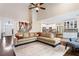 Open-concept living room showcasing hardwood floors, a staircase, and seamless access to the kitchen at 635 Piping Rock Pt, Lawrenceville, GA 30043