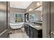 Main bathroom featuring double vanity, freestanding bathtub, tile floors, and modern fixtures at 635 Piping Rock Pt, Lawrenceville, GA 30043