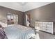 Main bedroom with a view to a sitting area and a walk-in closet, neutral colors, and carpet floors at 635 Piping Rock Pt, Lawrenceville, GA 30043