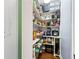 Spacious walk-in pantry with ample shelving for organized storage of food items and kitchen appliances at 635 Piping Rock Pt, Lawrenceville, GA 30043