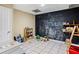 Spacious playroom featuring a chalkboard wall, tile floors, and shelving with toys at 635 Piping Rock Pt, Lawrenceville, GA 30043