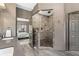 Luxurious tiled shower with glass door in the primary bathroom, plus granite countertop and seamless sink at 635 Piping Rock Pt, Lawrenceville, GA 30043