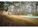 Extensive backyard with mature trees, a swimming pool, and room for outdoor activities at 1106 Oak Sw Rd, Lilburn, GA 30047
