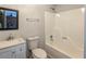 Bathroom features a shower-tub combo, a vanity sink and a wall mirror at 1106 Oak Sw Rd, Lilburn, GA 30047