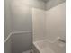 Clean bathtub with a modern surround in a well-maintained bathroom at 1106 Oak Sw Rd, Lilburn, GA 30047