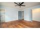 A spacious bedroom with hardwood floors and neutral walls, featuring multiple doorways leading to other rooms in the house at 1106 Oak Sw Rd, Lilburn, GA 30047