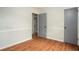 Spacious bedroom featuring hardwood floors, neutral walls with clean, white trim, and doorways to other parts of the home at 1106 Oak Sw Rd, Lilburn, GA 30047