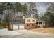 Charming two-story home with brick accents, front porch, and two-car garage at 1106 Oak Sw Rd, Lilburn, GA 30047