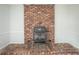 Rustic brick fireplace with a black accent stove as a cozy focal point at 1106 Oak Sw Rd, Lilburn, GA 30047