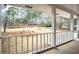 Covered front porch with white railing and a view of the landscaped front yard at 1106 Oak Sw Rd, Lilburn, GA 30047
