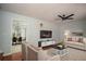 Bright living room featuring hardwood floors, ceiling fan, and access to the dining room at 1106 Oak Sw Rd, Lilburn, GA 30047