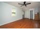 Living room with hardwood floors, windows, and a staircase to the second level at 1106 Oak Sw Rd, Lilburn, GA 30047