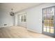 Bright living room featuring wood-look floors, pendant lighting, and a glass door to the outdoor deck at 1106 Oak Sw Rd, Lilburn, GA 30047