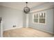 Bright living room featuring wood-look floors, an orb pendant light fixture and a window at 1106 Oak Sw Rd, Lilburn, GA 30047