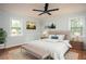 Well-lit main bedroom showcasing hardwood floors, a ceiling fan, and neutral decor, creating a comfortable and inviting retreat at 1106 Oak Sw Rd, Lilburn, GA 30047