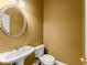 Charming half bath featuring a pedestal sink, round mirror, and neutral paint at 1211 Comet View Se Trl, Smyrna, GA 30082