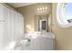 Bright bathroom with white vanity, round window and shower with curtain at 1211 Comet View Se Trl, Smyrna, GA 30082