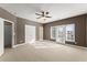 Spacious bedroom featuring a ceiling fan, large windows, and neutral carpeting at 1211 Comet View Se Trl, Smyrna, GA 30082