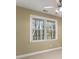Bedroom with a large window overlooking trees and tan carpet at 1211 Comet View Se Trl, Smyrna, GA 30082