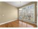 Bright dining room featuring hardwood floors, a modern chandelier, and a large window with natural light at 1211 Comet View Se Trl, Smyrna, GA 30082
