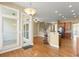 Open floor plan with hardwood floors connecting kitchen, staircase, dining area and stainless steel appliances at 1211 Comet View Se Trl, Smyrna, GA 30082