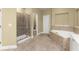 Main bath showcasing separate shower, soaking tub, and tile flooring at 1211 Comet View Se Trl, Smyrna, GA 30082