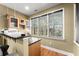 Wet bar with granite countertop, cabinets, and window overlooking trees at 1211 Comet View Se Trl, Smyrna, GA 30082