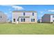 View of backyard featuring a spacious lawn and the home's rear exterior at 517 Elkwood Ln, Mcdonough, GA 30253